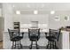 Bright kitchen featuring white cabinets, stainless steel appliances, and a large island with bar seating at 10136 Coral Shore Dr, Englewood, FL 34223