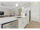 Elegant kitchen featuring stainless steel appliances, a large island, and white cabinetry at 10136 Coral Shore Dr, Englewood, FL 34223