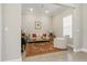 Elegant living room with neutral walls, refined decor, a classic piano, and modern lighting at 10136 Coral Shore Dr, Englewood, FL 34223