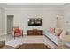Cozy living room with a large television, comfortable seating, and neutral decor at 10136 Coral Shore Dr, Englewood, FL 34223