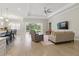 Inviting living room with backyard views, hardwood floors, and a cozy seating area at 10136 Coral Shore Dr, Englewood, FL 34223