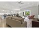 Spacious living room with an open layout, hardwood floors, a fireplace, and natural light at 10136 Coral Shore Dr, Englewood, FL 34223