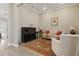 Bright living room featuring a classic piano, elegant furniture, and a stylish rug on light hardwood floors at 10136 Coral Shore Dr, Englewood, FL 34223