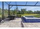 Outdoor living space with a brick patio, a beautiful view, and a hot tub for entertaining at 10136 Coral Shore Dr, Englewood, FL 34223