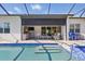 Screened-in lanai with inground pool, outdoor kitchen and patio furniture for relaxing at 10136 Coral Shore Dr, Englewood, FL 34223
