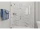 Shower features glass doors, tiled walls, rainfall shower head and a sleek design at 10136 Coral Shore Dr, Englewood, FL 34223