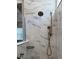 Close-up of a marble-tiled shower with dual shower heads and built-in shelving at 10136 Coral Shore Dr, Englewood, FL 34223