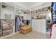 Walk-in closet features well-organized storage shelves and drawers for clothing and accessories at 10136 Coral Shore Dr, Englewood, FL 34223