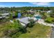 Aerial view of modern home featuring a private fenced yard, pool and nearby canal access at 106 Playmore Dr, Venice, FL 34293