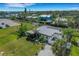 Aerial view of modern home in a neighborhood with nearby canal access and recreational waterways at 106 Playmore Dr, Venice, FL 34293