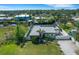Aerial view of modern home highlighting the fenced yard, clean roof and landscaping details at 106 Playmore Dr, Venice, FL 34293
