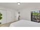 Bright bedroom features wood floors, closet, white walls, and view to the backyard at 106 Playmore Dr, Venice, FL 34293