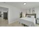 Inviting bedroom with bright walls and view into kitchen area from door at 106 Playmore Dr, Venice, FL 34293