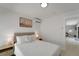 Bright bedroom features a clean contemporary design, wood floors and desert art at 106 Playmore Dr, Venice, FL 34293