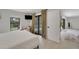Bright bedroom with sliding glass doors to the pool, hardwood floors, and television at 106 Playmore Dr, Venice, FL 34293