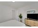 Bright bedroom featuring wood floors, clean design and television at 106 Playmore Dr, Venice, FL 34293