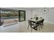 Dining room with sliding glass doors that offers view of private pool and back yard at 106 Playmore Dr, Venice, FL 34293