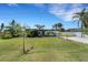 Well-manicured lawn and modern home with unique wood accents for a beautiful curb appeal at 106 Playmore Dr, Venice, FL 34293