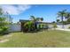 Modern home with fenced yard and lush landscaping, providing a private oasis at 106 Playmore Dr, Venice, FL 34293