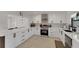 Well-lit kitchen with modern appliances, white cabinetry, and a modern design at 106 Playmore Dr, Venice, FL 34293