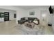 Comfortable living room with a sectional sofa, accent rug, and view to laundry room at 106 Playmore Dr, Venice, FL 34293