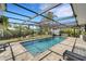 The beautiful screened pool area with a shimmering pool and comfortable seating, creates a perfect outdoor oasis at 106 Playmore Dr, Venice, FL 34293
