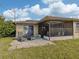 The backyard patio features outdoor seating, perfect for enjoying the Florida sunshine and backyard views at 1101 Southland Rd, Venice, FL 34293
