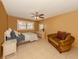 Bedroom with natural light, fan, tile floors, and a cozy seating area at 1101 Southland Rd, Venice, FL 34293