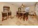 Open-concept dining room with tile flooring, a breakfast bar and views of the living area at 1101 Southland Rd, Venice, FL 34293