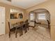 Open dining room featuring a glass table with seating for four and easy access to the living area at 1101 Southland Rd, Venice, FL 34293