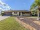 Beautiful home with a well-manicured lawn, palm trees, and a welcoming front porch at 1101 Southland Rd, Venice, FL 34293