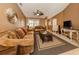 Welcoming living room showcasing neutral paint, a ceiling fan, plush seating and ample natural light at 1101 Southland Rd, Venice, FL 34293