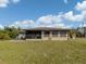 The home's rear exterior boasts a screened-in patio and outdoor seating area, perfect for entertaining at 1101 Southland Rd, Venice, FL 34293
