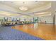 Large banquet hall with hardwood dance floor, carpeted social area and many tables and chairs at 11343 Bertolini Dr, Venice, FL 34292