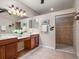 Bright bathroom with double vanity, lots of counter space and a tile shower at 11343 Bertolini Dr, Venice, FL 34292