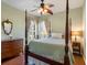 Bedroom with four poster bed, hardwood floors, and updated furnishings at 11343 Bertolini Dr, Venice, FL 34292