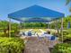 A covered shelter with seating and tables overlooking the bocce ball courts is great for gathering at 11343 Bertolini Dr, Venice, FL 34292