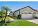 Charming single-story home with a lush lawn, mature landscaping, and a convenient two-car garage at 11343 Bertolini Dr, Venice, FL 34292
