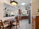 Open kitchen and dining area, showcasing wood cabinets, granite counters and stainless steel appliances at 11343 Bertolini Dr, Venice, FL 34292