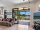 Cozy living room with tile floors and a large sliding glass door leading to the lanai at 11343 Bertolini Dr, Venice, FL 34292