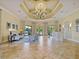 Beautiful lobby with tile flooring, coffered ceiling, and elegant lighting at 11343 Bertolini Dr, Venice, FL 34292