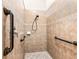 Updated tile shower with safety bars and ample space, designed for accessibility and comfort at 11343 Bertolini Dr, Venice, FL 34292