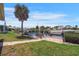 A view of a backyard canal with boats docked along the water, a seating area, and manicured grass at 120 Villa Dr # 120, Osprey, FL 34229