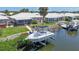 Features a boat in a boat lift with a dock at 120 Villa Dr # 120, Osprey, FL 34229