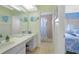 Bright bathroom featuring a vanity with solid surface countertops and a tiled walk-in shower at 120 Villa Dr # 120, Osprey, FL 34229