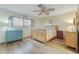 Cozy bedroom with wood-look floors, ceiling fan and comfortable furnishings at 120 Villa Dr # 120, Osprey, FL 34229