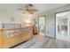 Comfortable bedroom featuring wood-look floors, ceiling fan and view to the bathroom at 120 Villa Dr # 120, Osprey, FL 34229