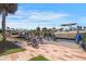 Dock and patio with chairs overlooking canal, boats, and beautiful blue sky at 120 Villa Dr # 120, Osprey, FL 34229