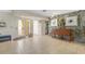 Bright entryway with tiled floors, stone accent wall, and decorative chest with coastal artwork at 120 Villa Dr # 120, Osprey, FL 34229