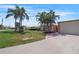 Charming home featuring a well-manicured lawn, beautiful landscaping, and a convenient driveway at 120 Villa Dr # 120, Osprey, FL 34229